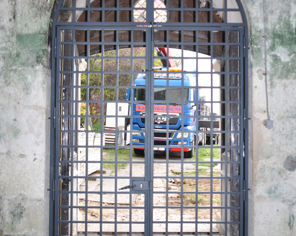 Grille en fer forgé pour protéger l'entrée d'une Eglise